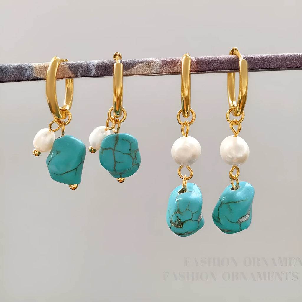 A pair of women's geometric drop earrings with irregular turquoise stones and round cultured pearls on copper settings.