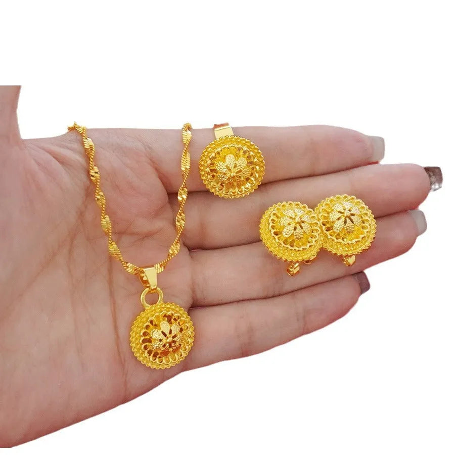 Gold-plated three-piece jewellery suit with landscape Middle East flower designs showing earrings, ring and pendant necklace
