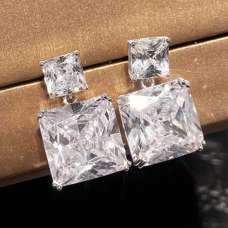 A pair of geometric square design earrings for women in a gold colour finish, made from copper.
