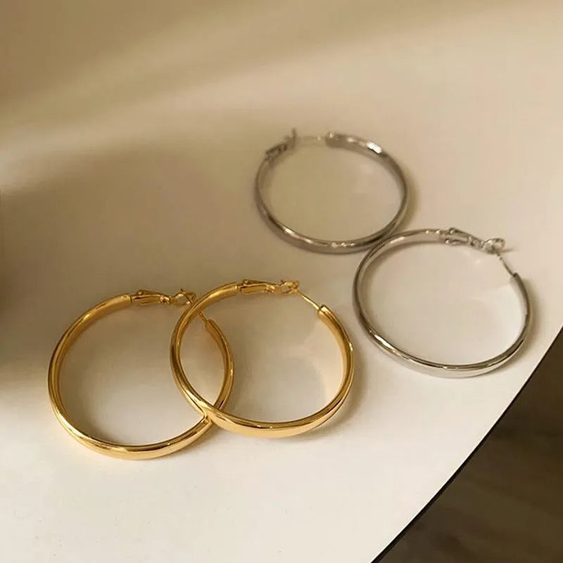 40mm diameter gold and silver metal circle earrings on display