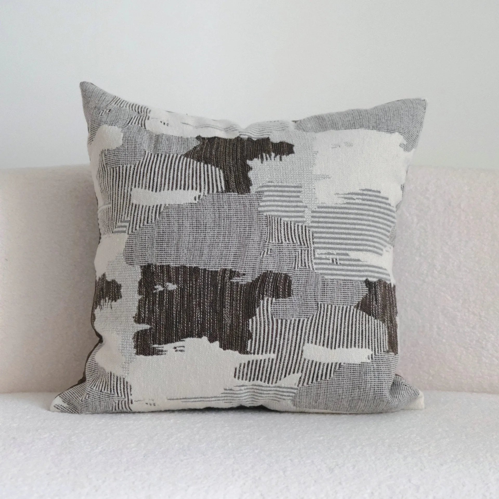 Coffee brown striped Chinese classical style decorative sofa cushion on a grey sofa.