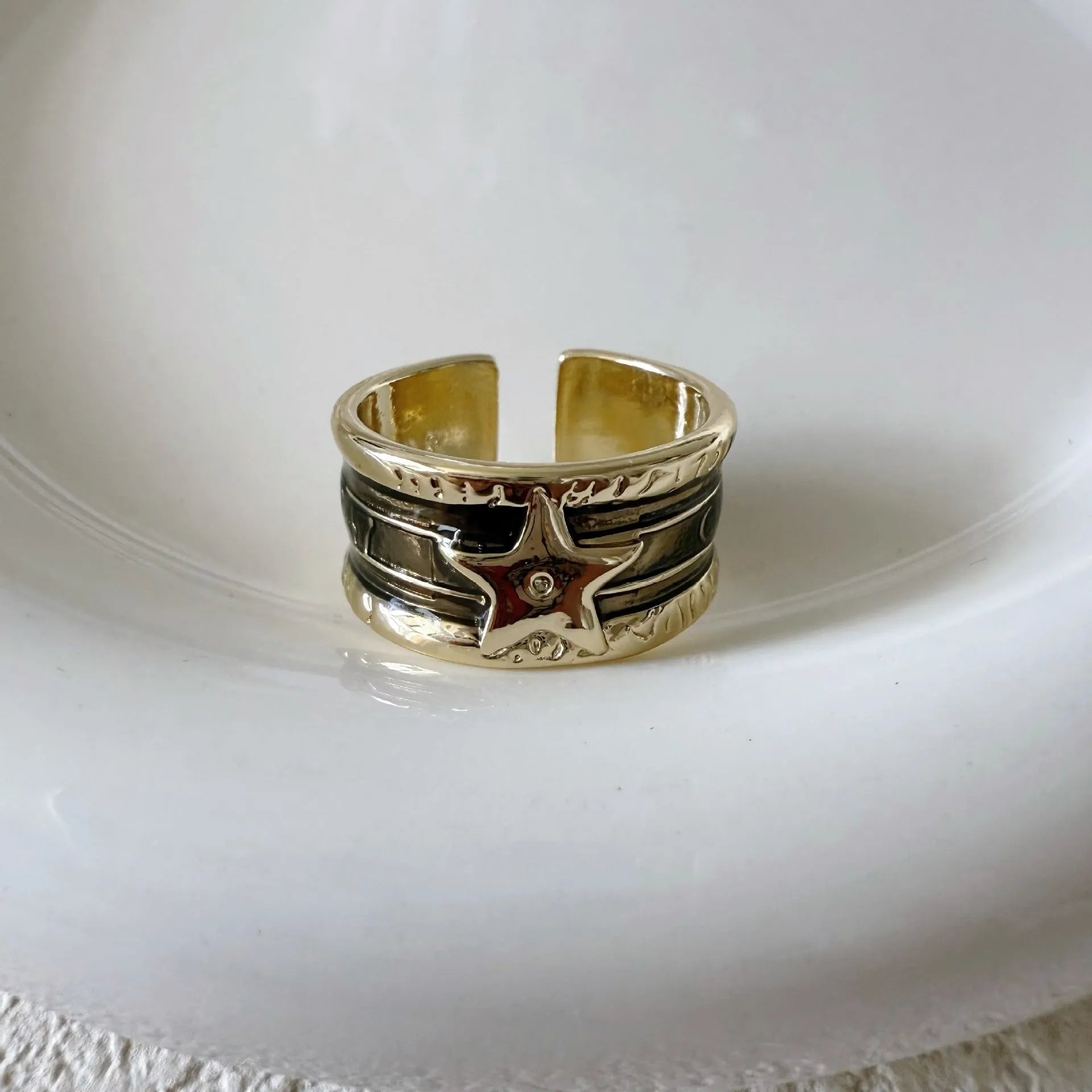 Geometric drop ring with distressed finish and adjustable band