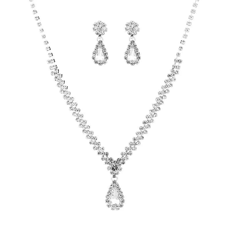 Women's blue claw chain necklace and drop rhinestone earrings from a matching jewellery set.