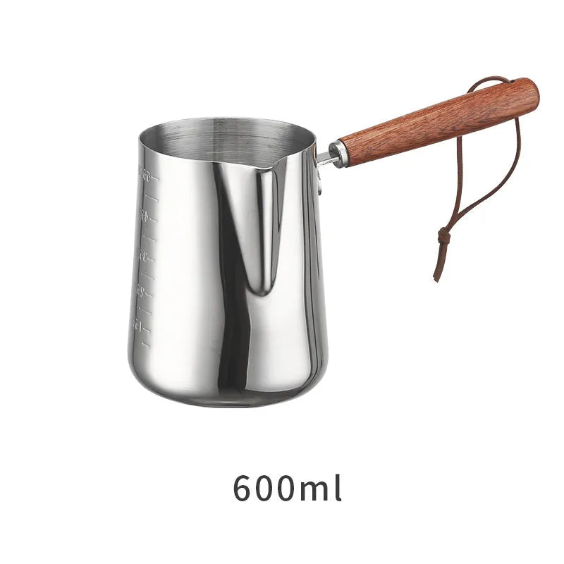 Stainless steel milk frothing jug with volume scale and wooden handle in three size options.