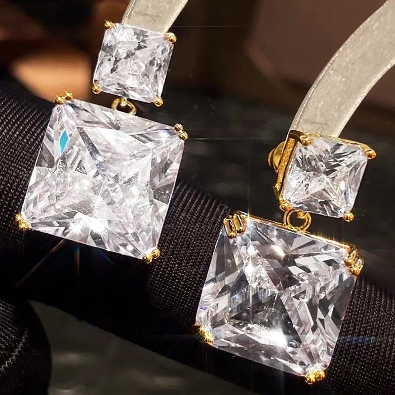 A pair of geometric square design earrings for women in a gold colour finish, made from copper.