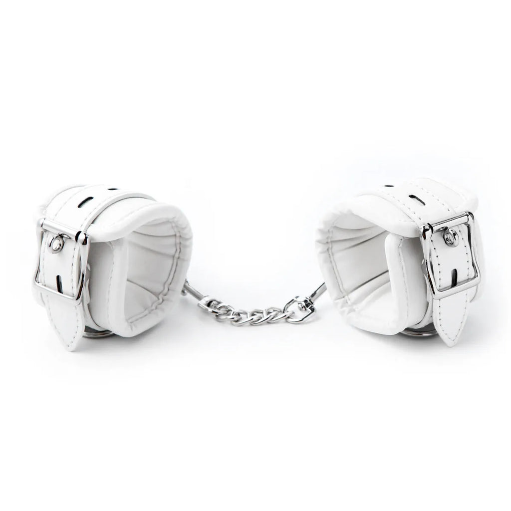White PU sponge bondage set showing handcuffs, foot cuffs, and neck cuff for adult restraint