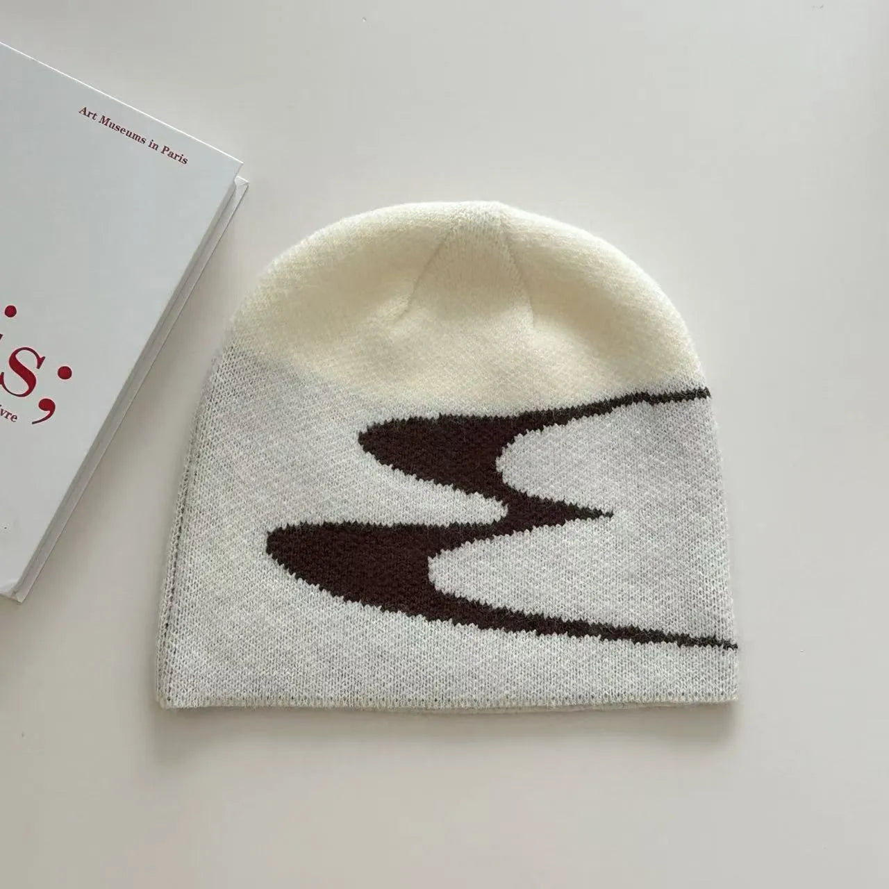A black knitted acrylic beanie hat for men and women, size M for winter.