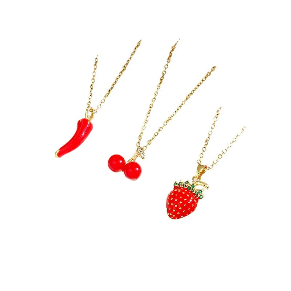 Women's titanium steel necklace with O-ring chain showing cherry, strawberry, and pepper charm options.