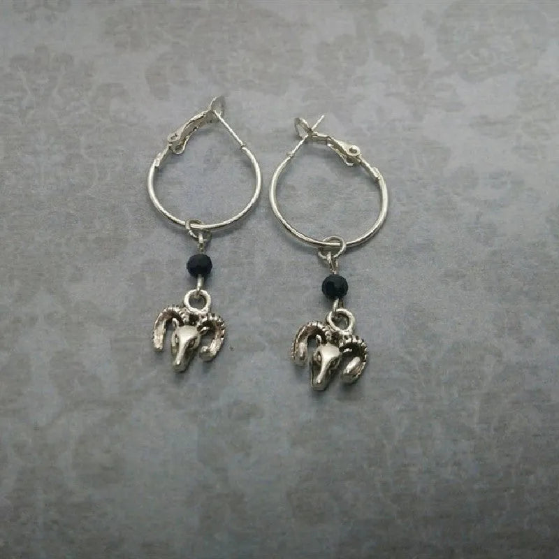 Silver-coloured round ring earrings for women featuring a raised Tibetan antelope design on an alloy metal hoop.