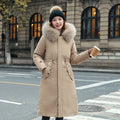 Women's long beige fleece trench coat with a belt, shown on a model.