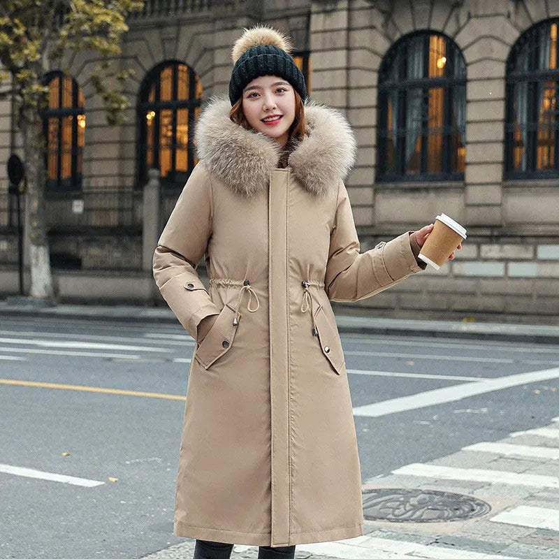 Women's long beige fleece trench coat with a belt, shown on a model.