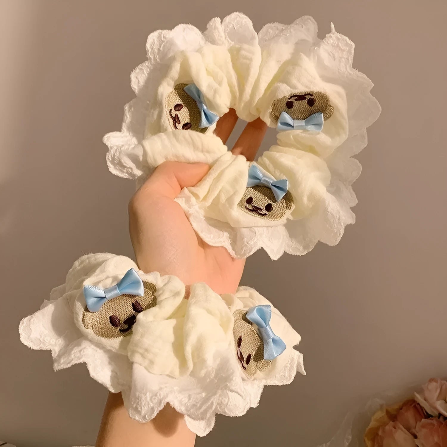 Blue cloth hair ring with bear motif and bow detailing, elastic construction