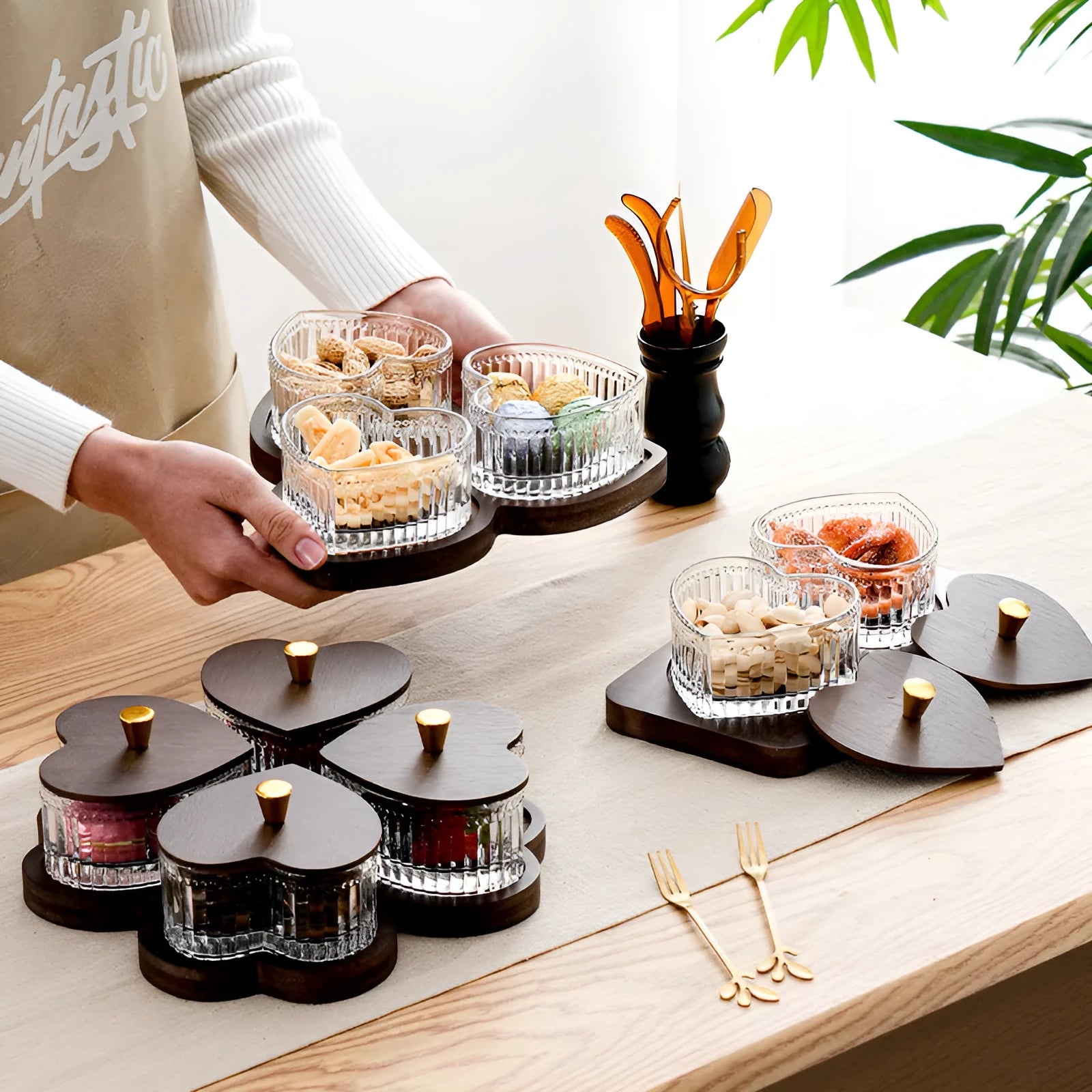 Glass retro-style snack platter with coloured glaze and a transparent heart-shaped lid over multiple compartments.