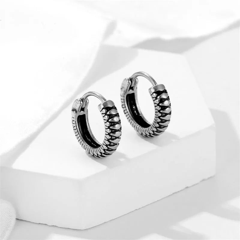 Silver geometric stud earrings with a retro striped twist pattern, made from titanium steel.