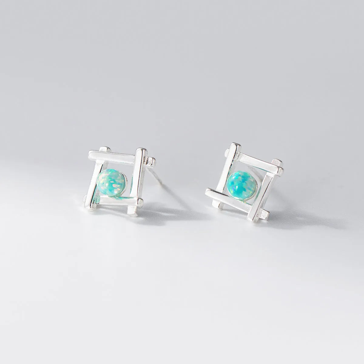 Geometric cross stud earrings in sterling silver with gold or silver plating options