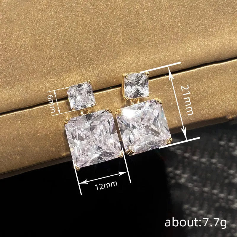 A pair of geometric square design earrings for women in a gold colour finish, made from copper.