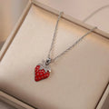 Women's titanium steel necklace with O-ring chain showing cherry, strawberry, and pepper charm options.