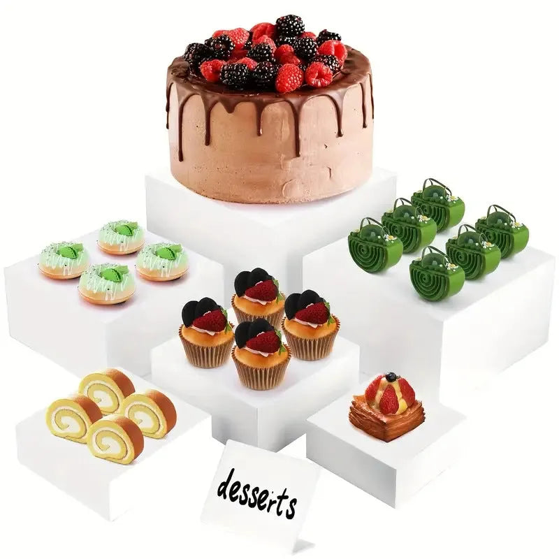 Set of six white geometric plastic cubes arranged as a tiered dessert display stand.