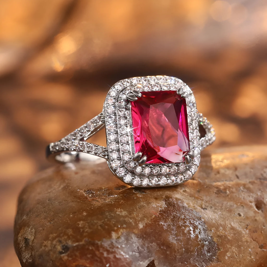 Copper square princess ring with red rhinestones on a geometric band.