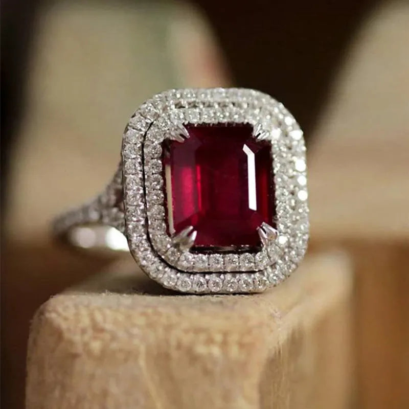 Copper square princess ring with red rhinestones on a geometric band.
