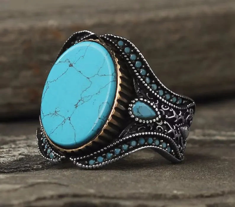 Men's round turquoise ring with antique silver finish showing circular alloy band design