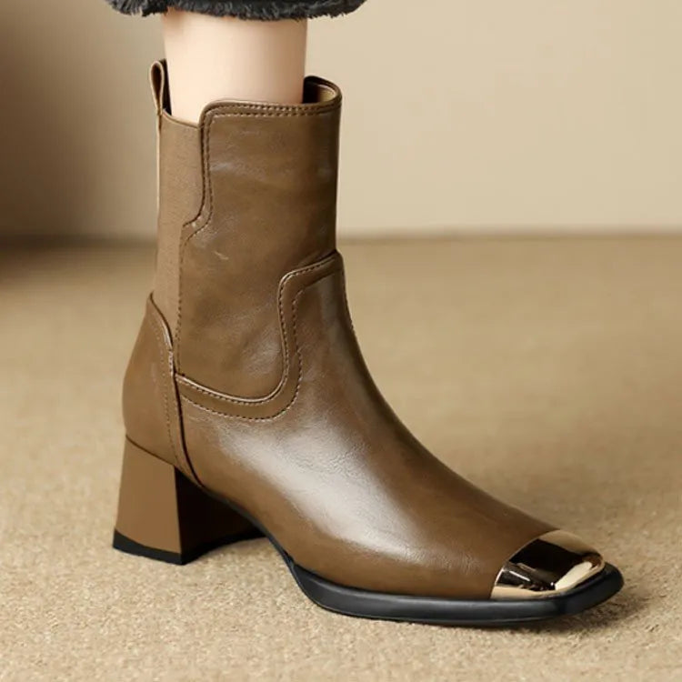 Brown women's Martin boots with side zipper and decorative metal details on a rubber sole.