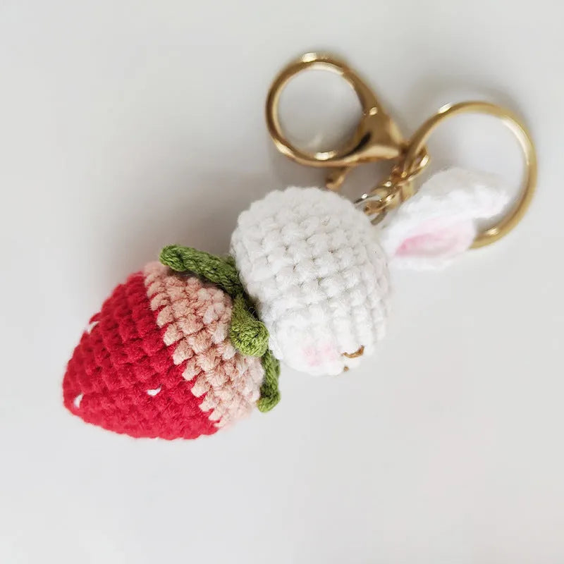 White hand-woven rabbit strawberry pendant on key with cartoon-style wire construction
