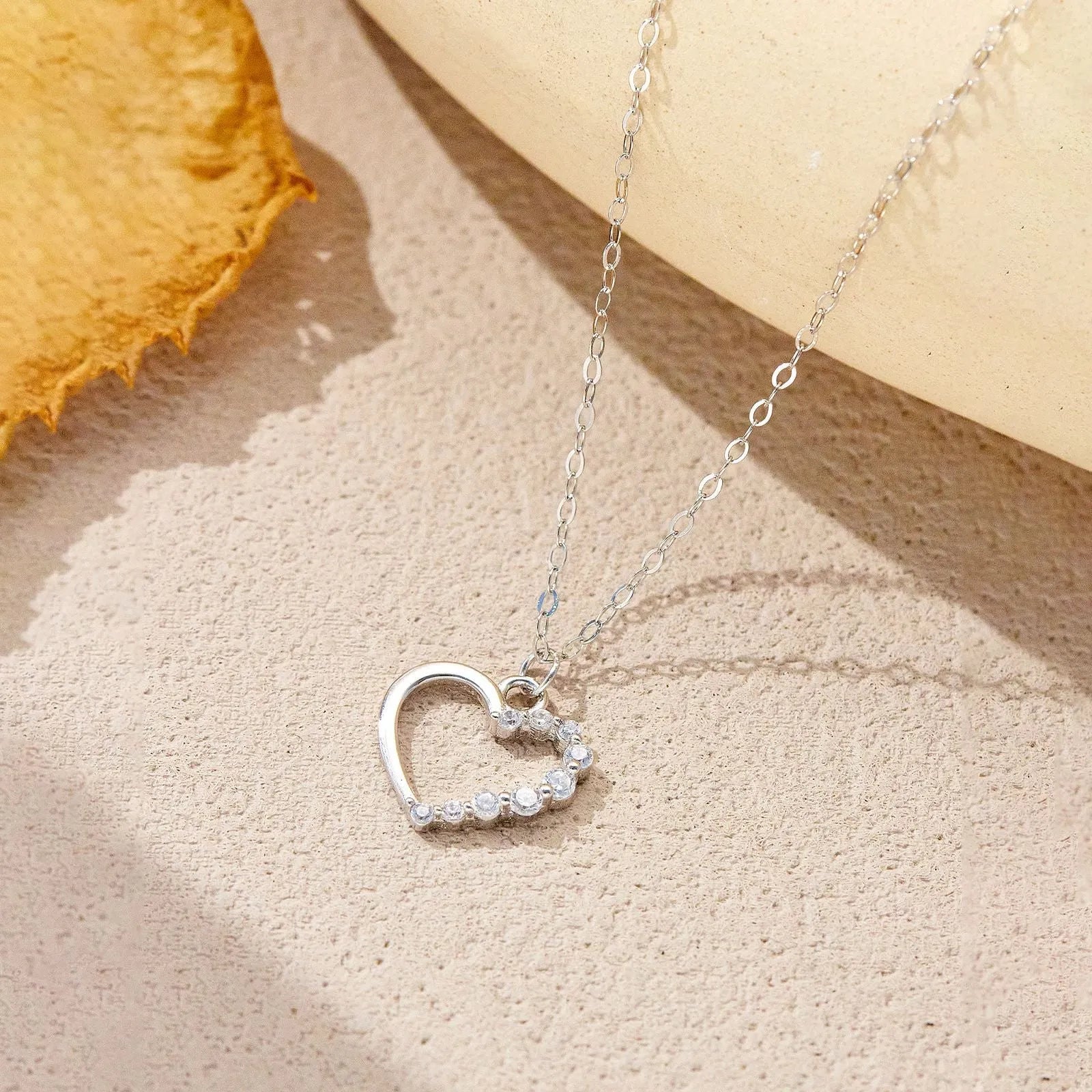 S925 sterling silver hollow heart necklace on a regular chain, shown in gold and platinum finish options.