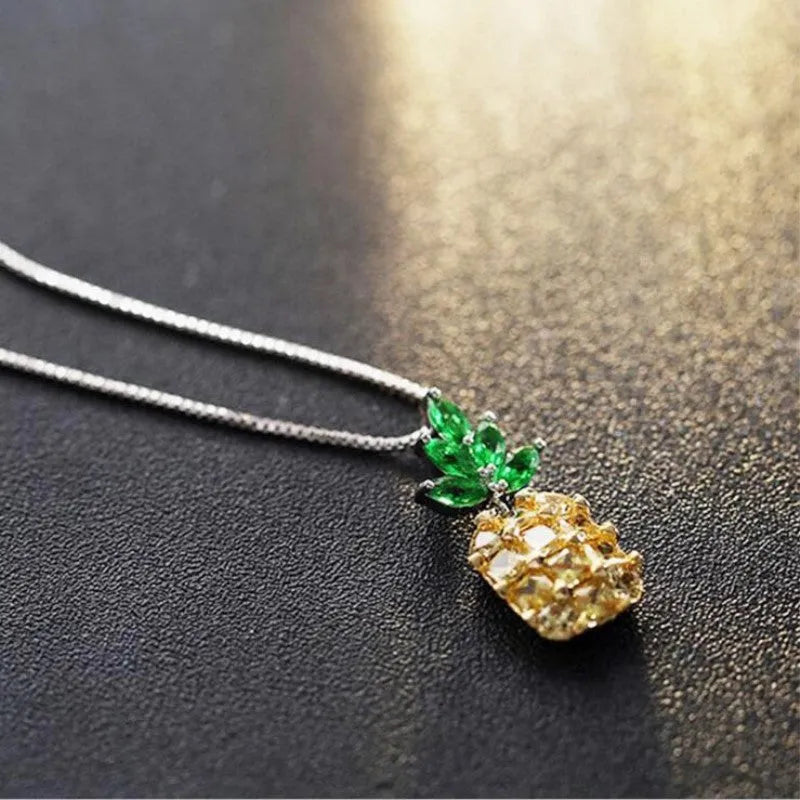 Silver pineapple charm necklace with geometric diamond design details