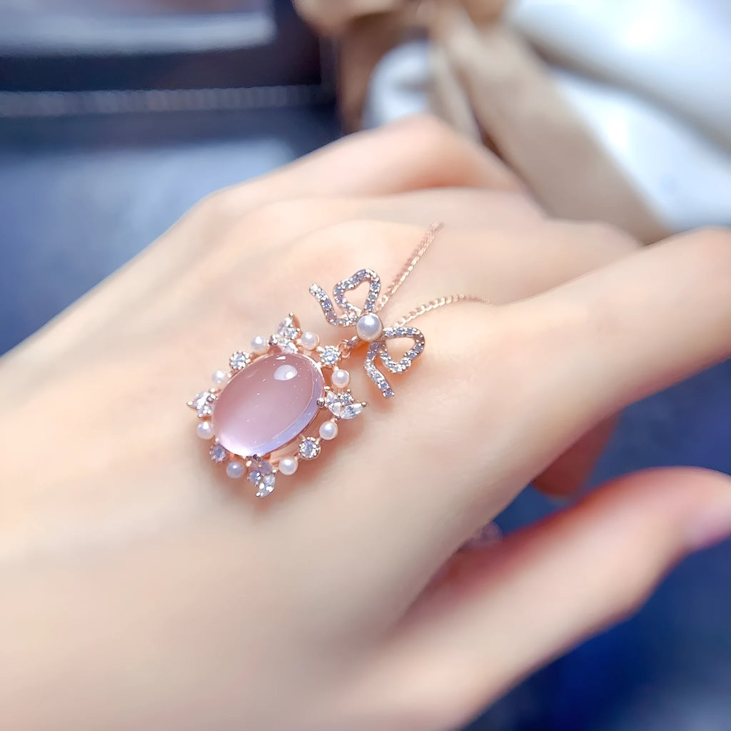 Geometric rose gold plated silver pendant with a natural pink rose quartz crystal on a chain.