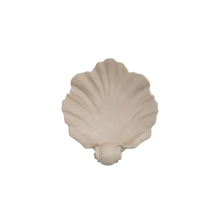 White resin shell-shaped fruit plate ornament on a table.