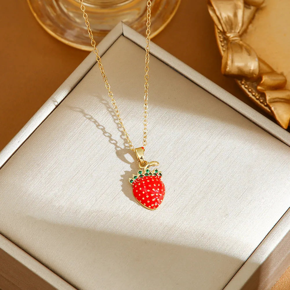 Women's titanium steel necklace with O-ring chain showing cherry, strawberry, and pepper charm options.