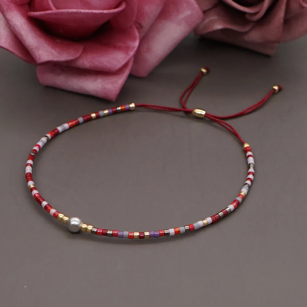 Women's handmade colourful beaded bracelet with geometric glass beads on adjustable cord