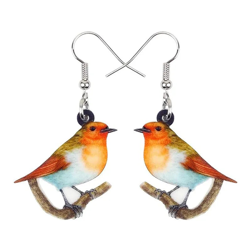 Blue Titmouse bird pendant acrylic earrings with geometric shapes and snake zodiac motifs.