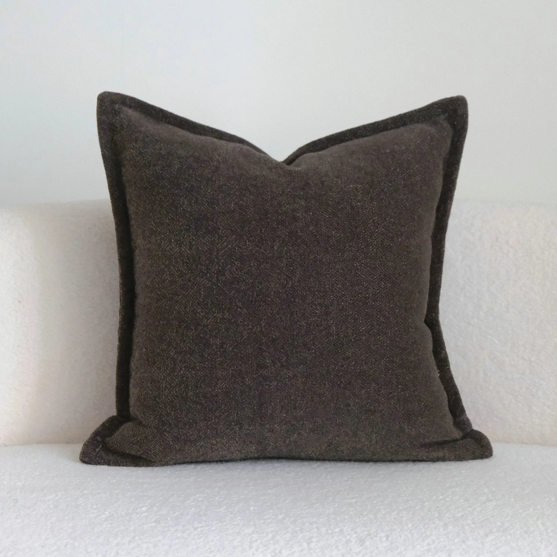 Coffee brown striped Chinese classical style decorative sofa cushion on a grey sofa.