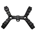 Black leather chest harness strap with a metal buckle and rivets on a neutral background.