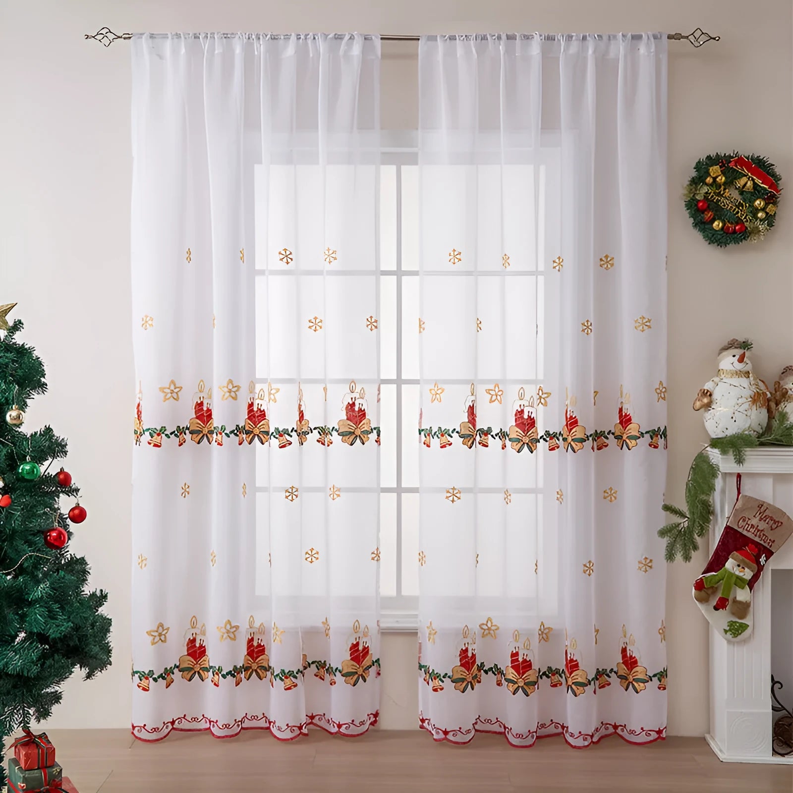 Pair of white Christmas curtains with embroidered red and green snowflake design, hung on a window.