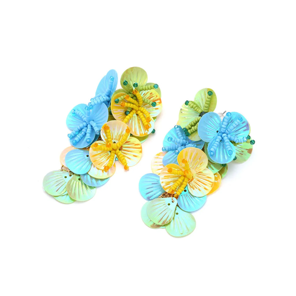 Close-up of colourful handmade bead flower earrings with leaves in European exaggerated style.