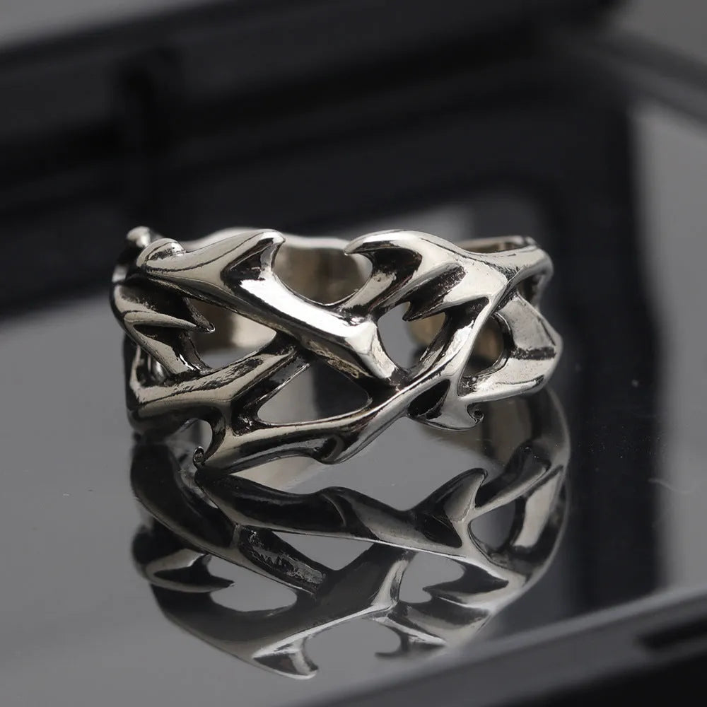 Adjustable copper men's ring with geometric thorn and flower design showing opening mechanism
