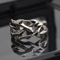 Adjustable copper men's ring with geometric thorn and flower design showing opening mechanism
