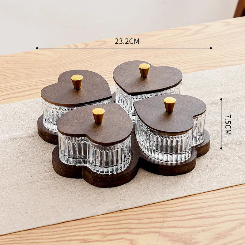 Glass retro-style snack platter with coloured glaze and a transparent heart-shaped lid over multiple compartments.