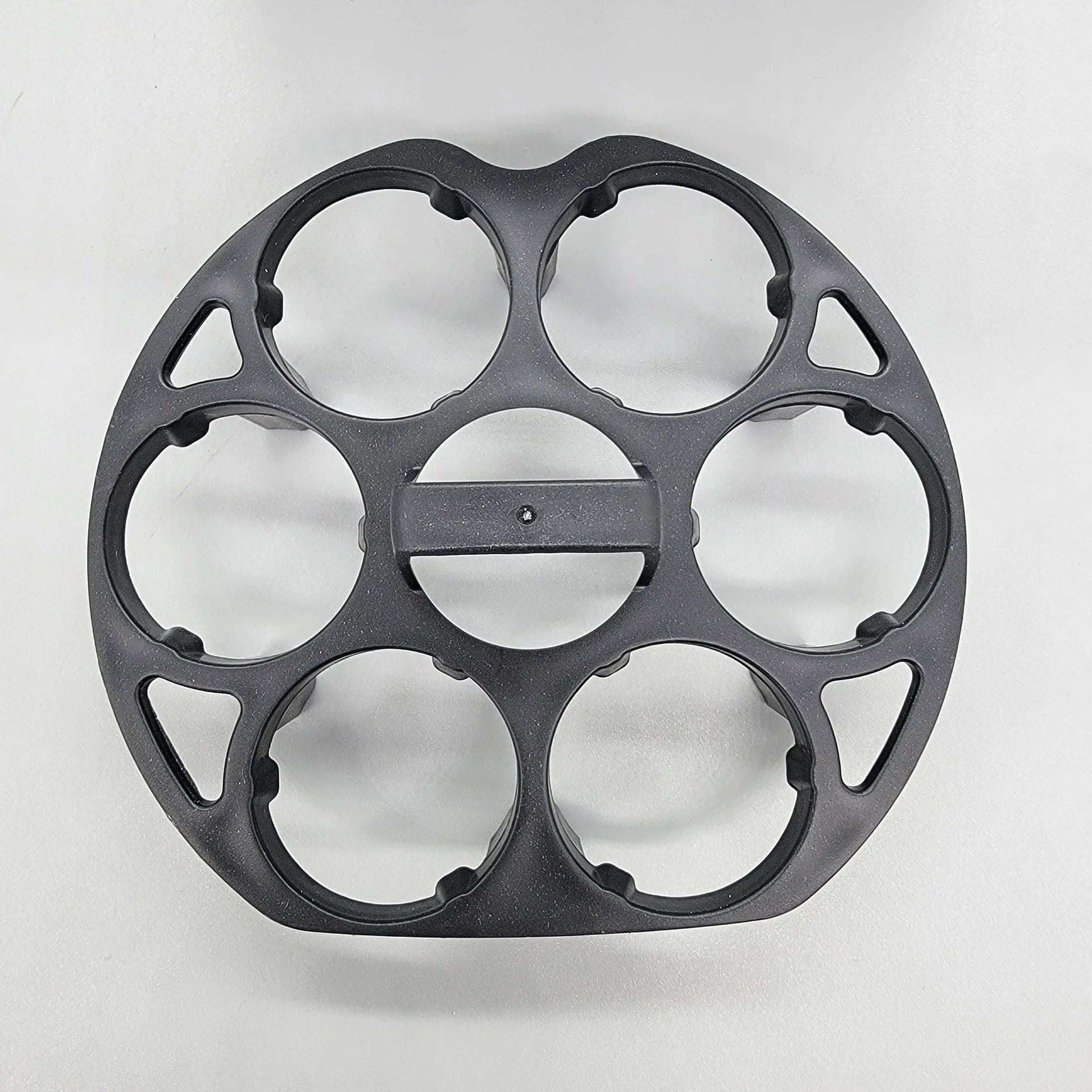 Black plastic egg holder rack with retainer for kitchen storage.