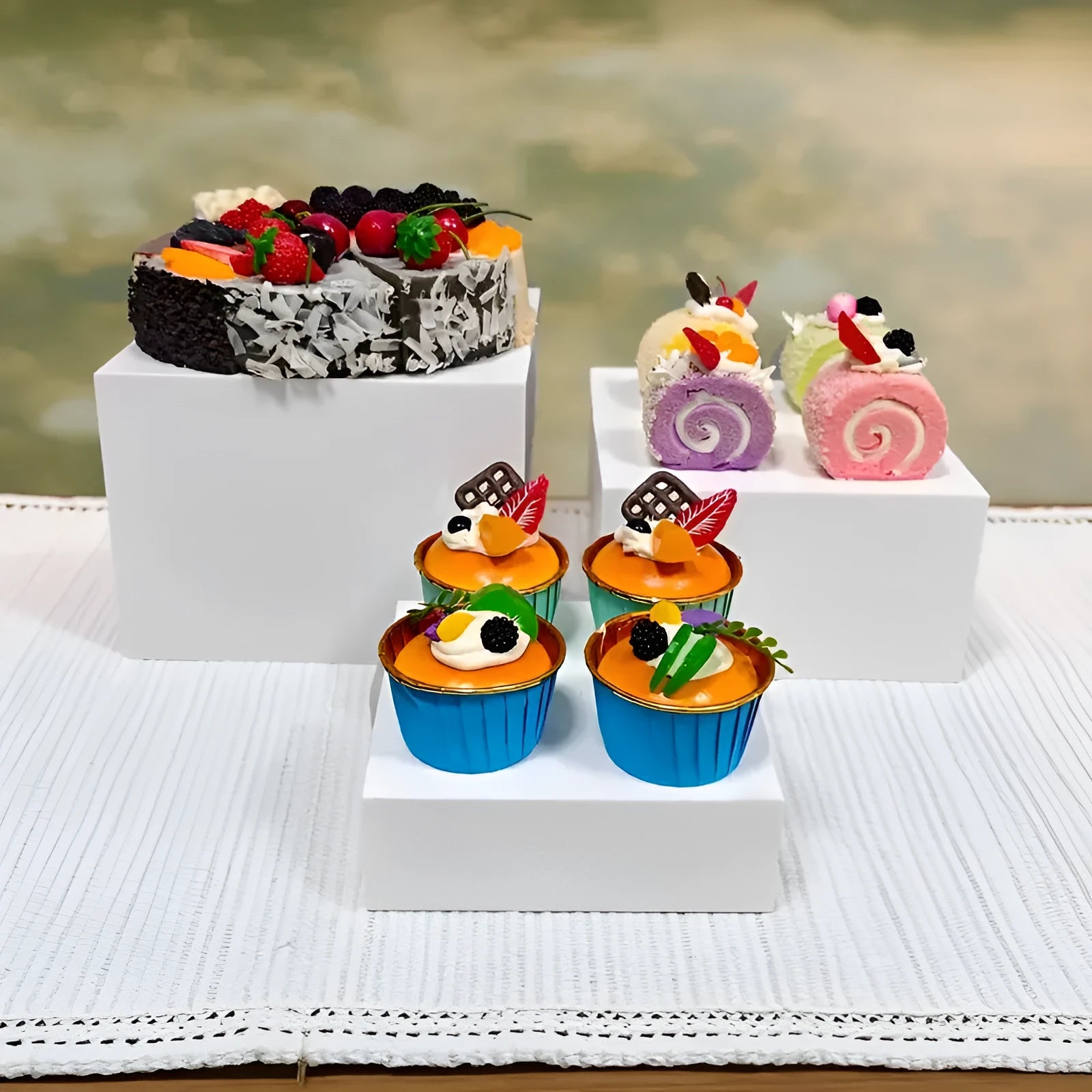Set of six white geometric plastic cubes arranged as a tiered dessert display stand.