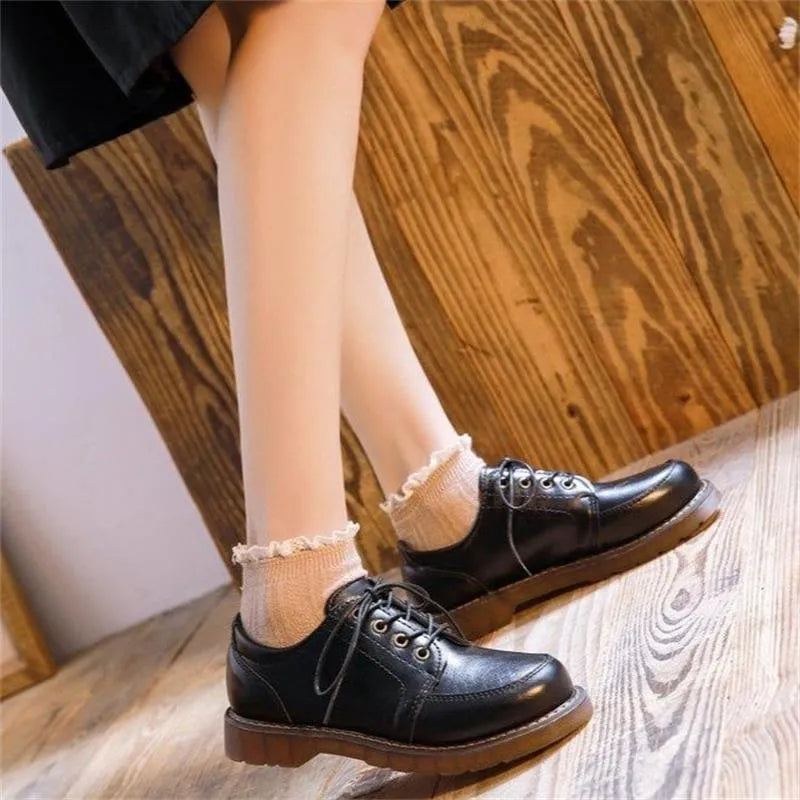 Black retro women's Mary Jane shoes with front lace-up and low square heel.