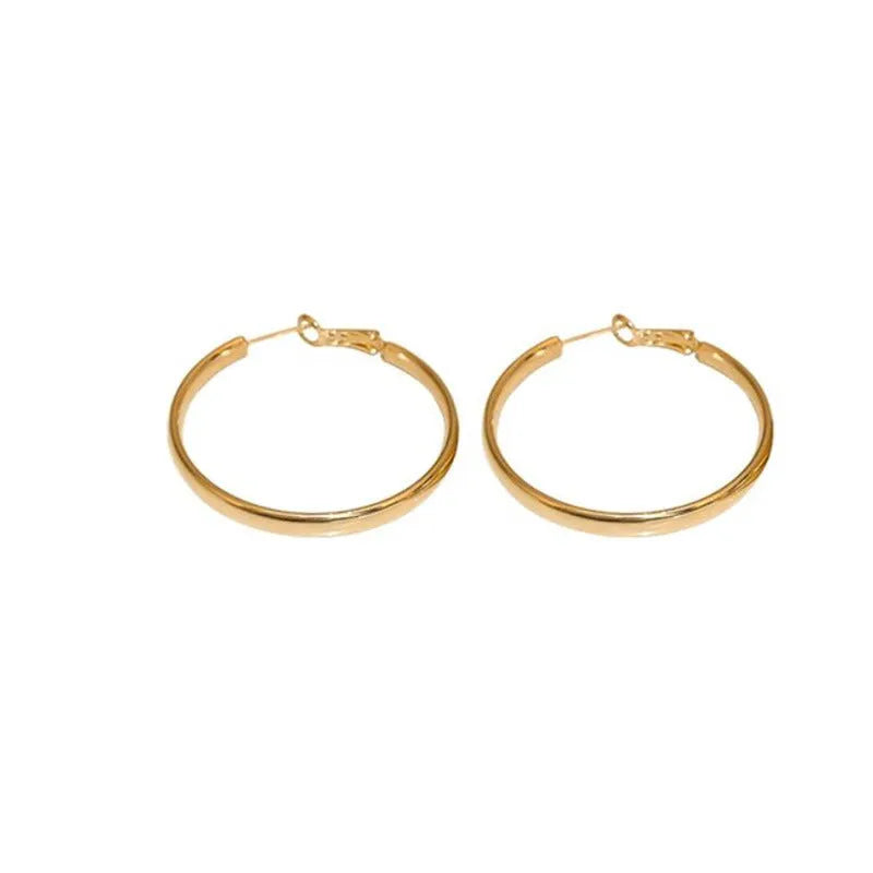 40mm diameter gold and silver metal circle earrings on display