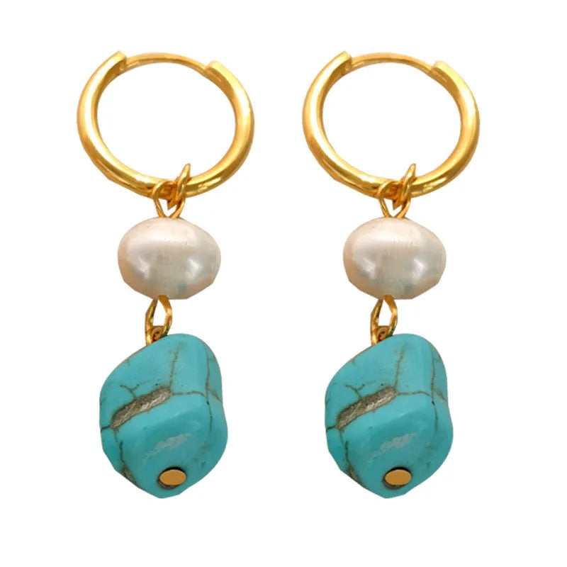 A pair of women's geometric drop earrings with irregular turquoise stones and round cultured pearls on copper settings.