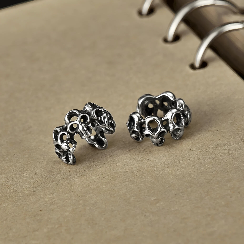 Stainless steel skull clip earrings with geometric hollow design and metallic finish