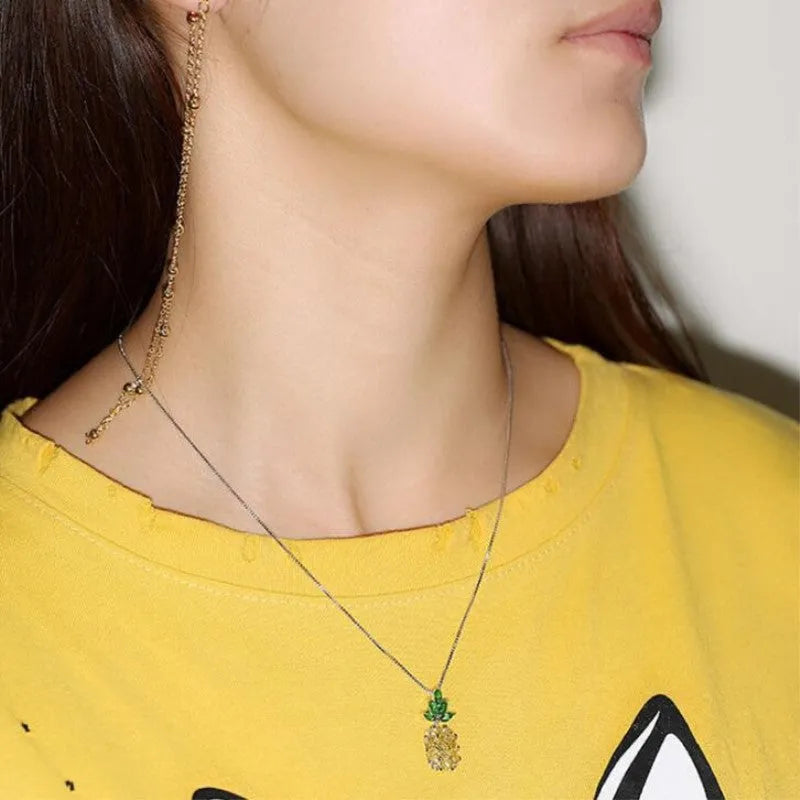 Silver pineapple charm necklace with geometric diamond design details