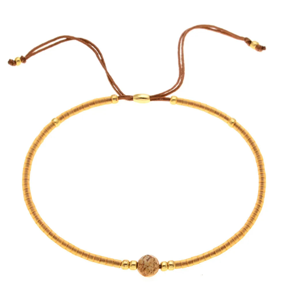 Women's handmade colourful beaded bracelet with geometric glass beads on adjustable cord