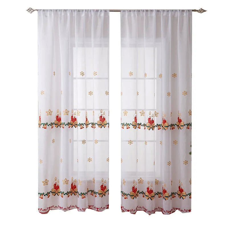 Pair of white Christmas curtains with embroidered red and green snowflake design, hung on a window.